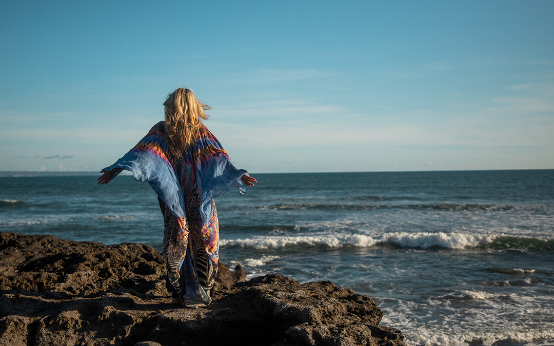 Woman standing at ocean